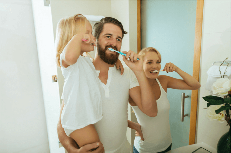 preventing cavities family brushing teeth