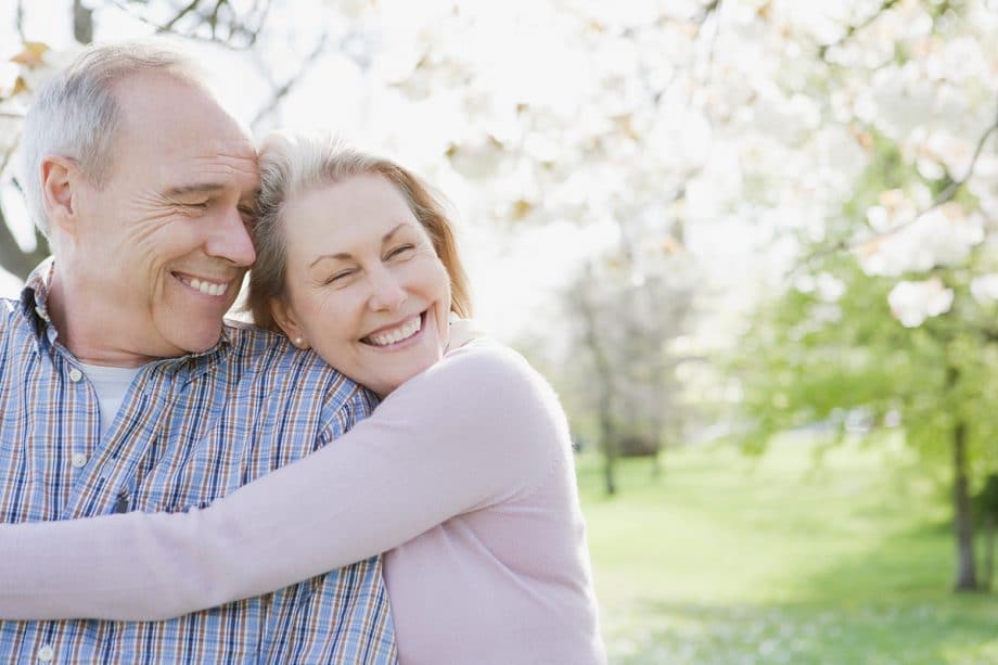 happy older woman hugging older man