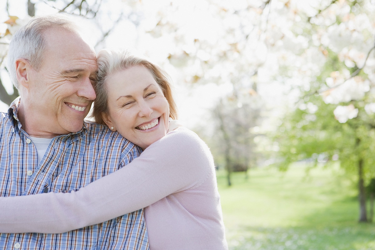 happy older woman hugging older man