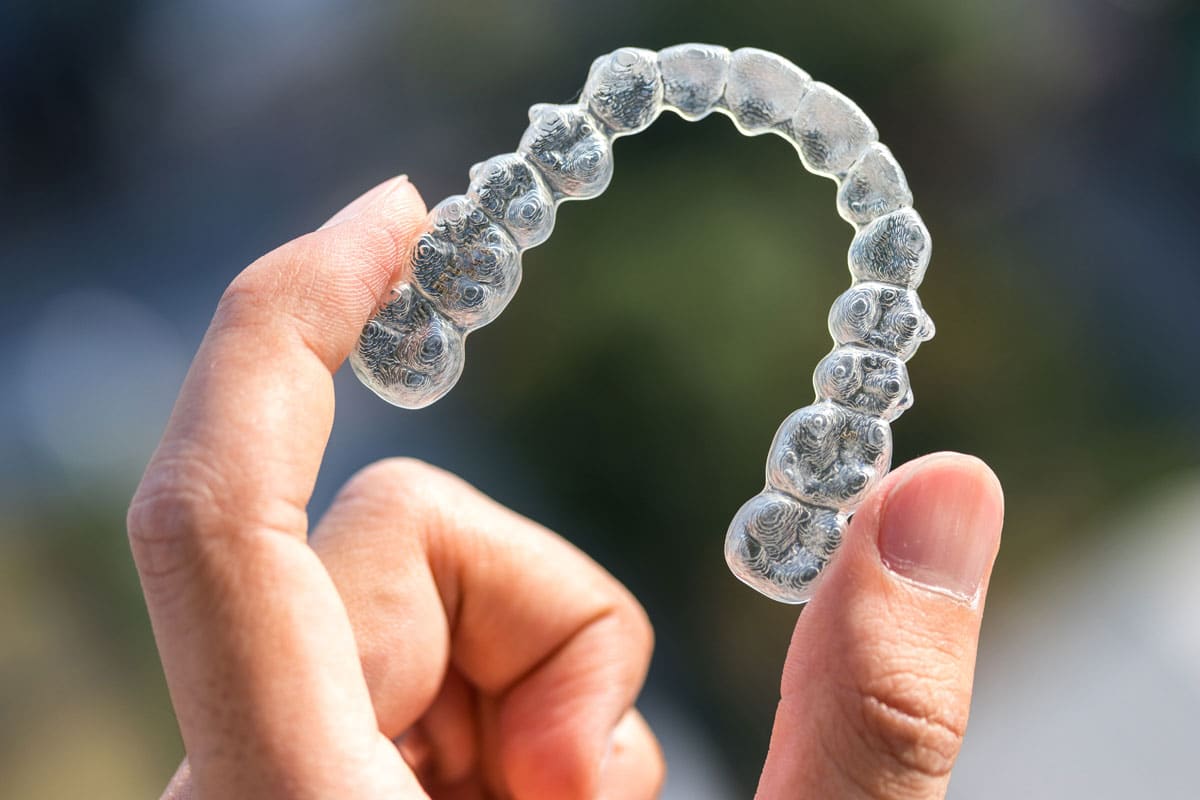 hand holding invisalign retainer