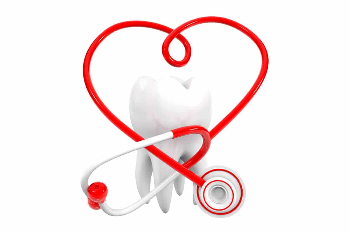 red stethoscope making heart in front of tooth model