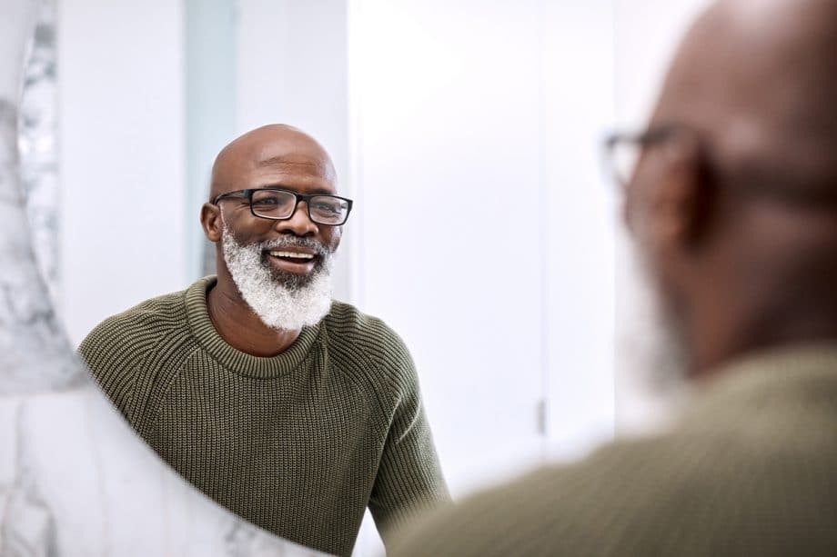 mature man smiling in the mirror